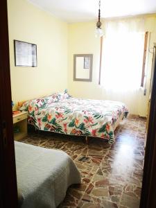 托里诺迪桑格罗vacanze al Mare appartamento in villa的一间卧室设有两张床和窗户。