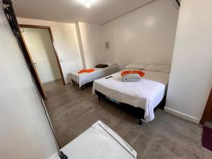 帕劳阿佩巴斯Dantas Hotel的带两张床和镜子的客房