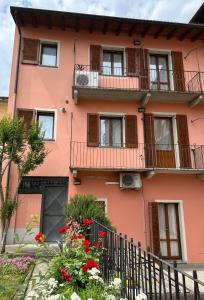克雷莫纳Appartamento 2 poggioli的一座粉红色的建筑,设有阳台和鲜花