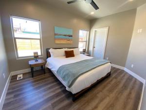 卡纳布Timber & Tin G 2Bed 2Bath w Pool & Rooftop Deck的一间卧室设有一张大床和两个窗户。