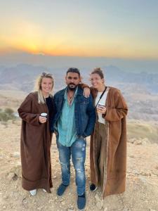 瓦迪穆萨Petra Desert Dream Hotel的三位站在山顶的一群人