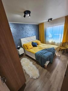 阿克雷里Flat in Akureyri的一间卧室配有一张带黄床单和地毯的床。