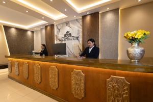 库斯科Hotel Hacienda Cusco Plaza的两位坐在前台的人