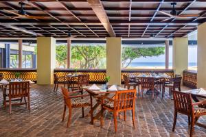 本托塔Heritance Ahungalla的一间带桌椅的海景餐厅