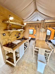 莱科Glamping Camping Rivabella的一个小大篷车的厨房和用餐区