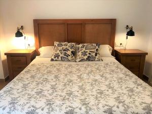 隆达隆达中心恩艾尔公寓的一张带两个枕头的床和两个床头柜