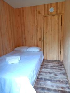 VahtseliinaVastseliina Metskond Camping的木墙客房的一张床位