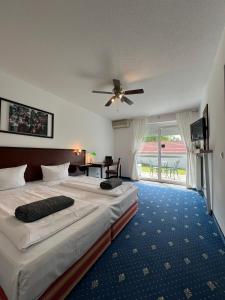 哈尔伯格摩斯Air Muc Park Sleep & Fly的酒店客房配有两张床和吊扇。