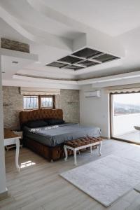 阿拉尼亚Yıldız Villa的一间卧室配有一张床和长凳