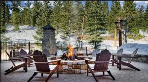 特拉基Hyatt Vacation Club at Northstar Lodge的火坑、椅子、桌子和壁炉