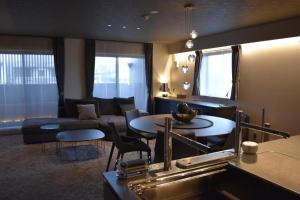京都HOTEL MASTAY jingumichi的客厅配有沙发和桌椅