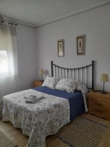 RiveroCasa Pili的一间卧室配有一张带蓝白色毯子的床