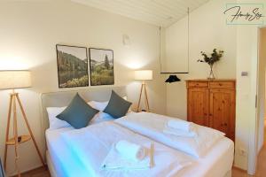 贝里斯泽尔Homely Stay Velosoph Quartier的卧室配有带蓝色枕头的大型白色床
