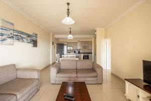 乌旺戈海滩Saints View Resort Unit 19的客厅配有两张沙发和一张桌子