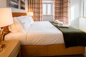 里斯本Comtesse Lisbonne Guest House by Homing的一间卧室配有一张床,上面有两条毛巾
