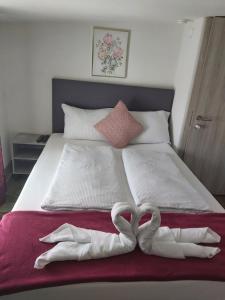 马里博尔Panda Rooms的床上的两条心形毛巾