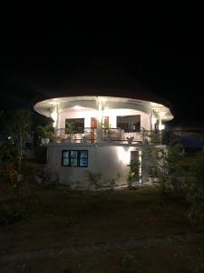 巴迪安Cuestas Beach Resort and Restaurant的夜晚有灯的白色房子