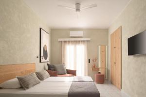 普拉基亚斯普拉基亚斯阿波罗酒店的一间卧室配有一张大床和电视