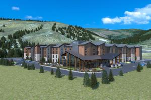 埃文TownePlace Suites by Marriott Avon Vail Valley的山 ⁇ 的建筑的 ⁇ 染