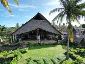 UtendeMafía Island Lodge的棕榈树房屋的外部景色