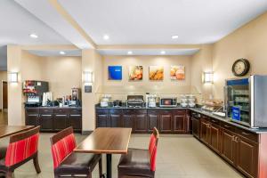 奥兰多奥兰多机场舒适套房酒店的一个带桌椅的大厨房