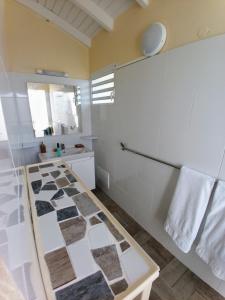 大博格Aux Colibris Amoureux : loft de standing avec vue mer的浴室设有 ⁇ 制地板
