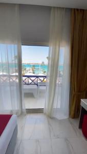阿莱曼premium sea porto marina suite的卧室设有海景大窗户