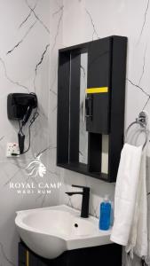 瓦迪拉姆ROYAl WADI RUM CAMP的浴室设有白色水槽和镜子