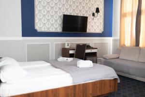 谢德尔采卡米尼卡酒店的酒店的客房 - 带一张床、椅子和电视