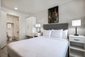 欧文Soka Suites Dallas - Las Colinas的一间带白色大床的卧室和一间浴室