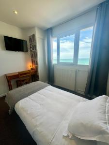 滨海圣奥班Le Clos Normand的卧室设有一张白色大床和大窗户