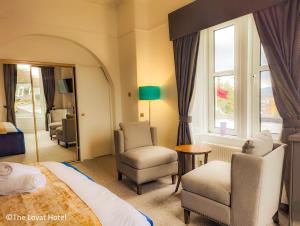 珀斯The Lovat Hotel的酒店客房带床、椅子和窗户