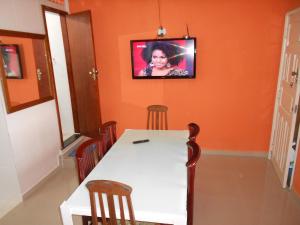 里约热内卢塔瓦雷斯巴斯托斯旅舍的一间设有桌子和墙上电视的用餐室