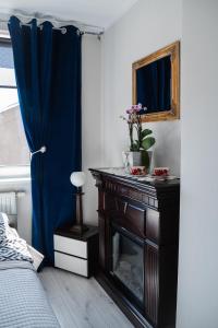 奥斯特罗达Welcome的一间卧室配有一张桌子、一个壁炉和一个镜子