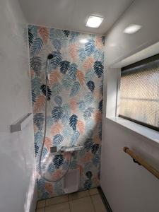 来民民泊サライ七城的浴室设有色彩缤纷的墙壁和淋浴。