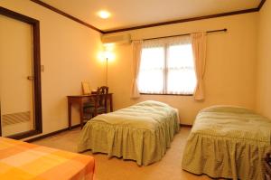 白马村西有酒店的一间卧室设有两张床和窗户。