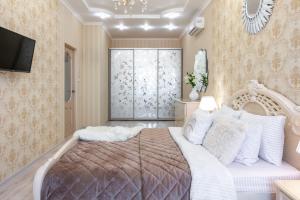 敖德萨Красивая квартира в ЦЕНТРЕ Одессы的一间带大床和电视的卧室