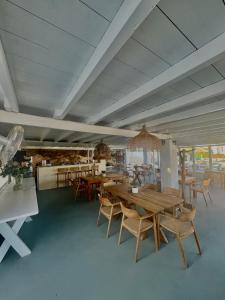 纳乌萨阿尼莫伊度假酒店的用餐室配有木桌和椅子