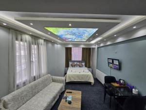 乌沙克Uyu Room Uşak Otel的客厅配有沙发和1张床