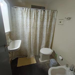 波萨达斯Casa céntrica muy comoda的浴室配有水槽、卫生间和浴帘