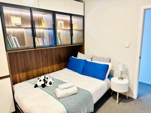 汉密尔顿Modern Comfy 3 Bedrooms House in Chartwell的一间卧室配有一张带蓝色枕头的床。