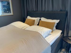 桑讷菲尤尔Guesthouse Suite by HC, centrally located, free parking的一张配有白色床单和棕色枕头的大床