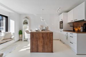 斯图加特Stuttgart Lux Living - Stilvolles Wohnen Im Zentrum的一间厨房,配有白色的橱柜和木制岛屿