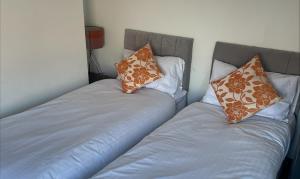 FerryhillQuirky and Cosy Self Contained Flat, Ferryhill Near Durham的两张睡床彼此相邻,位于一个房间里