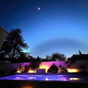 圣雷米普罗旺斯Les Logis de Cocagne的享有月亮游泳池的夜景