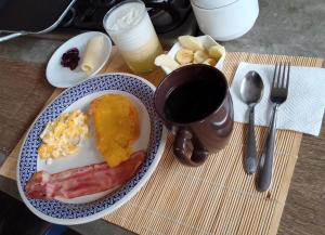 Hogar de Adriane Bed and breakfast cerca al aeropuerto的桌上的一盘早餐食品
