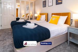 彼得伯勒Luxury 6 Bedroom Contractor House By Your Lettings Short Lets & Serviced Accommodation Peterborough With Free WiFi的配有黄色枕头的酒店客房的两张床