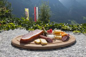 圣马蒂诺Gasthaus Jaufenblick的桌上的一盘奶酪和水果