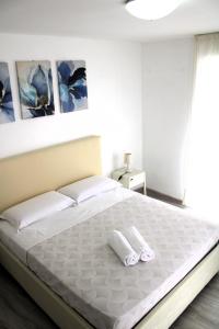 卡斯特拉玛雷帝斯达比亚I Balconcini Sul Porto的卧室配有一张带2条毛巾的大型白色床
