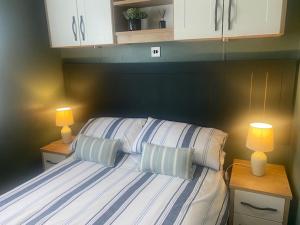 克利夫罗16 Lake View, Pendle View Holiday Park, Clitheroe的一间卧室配有一张带两个枕头的床